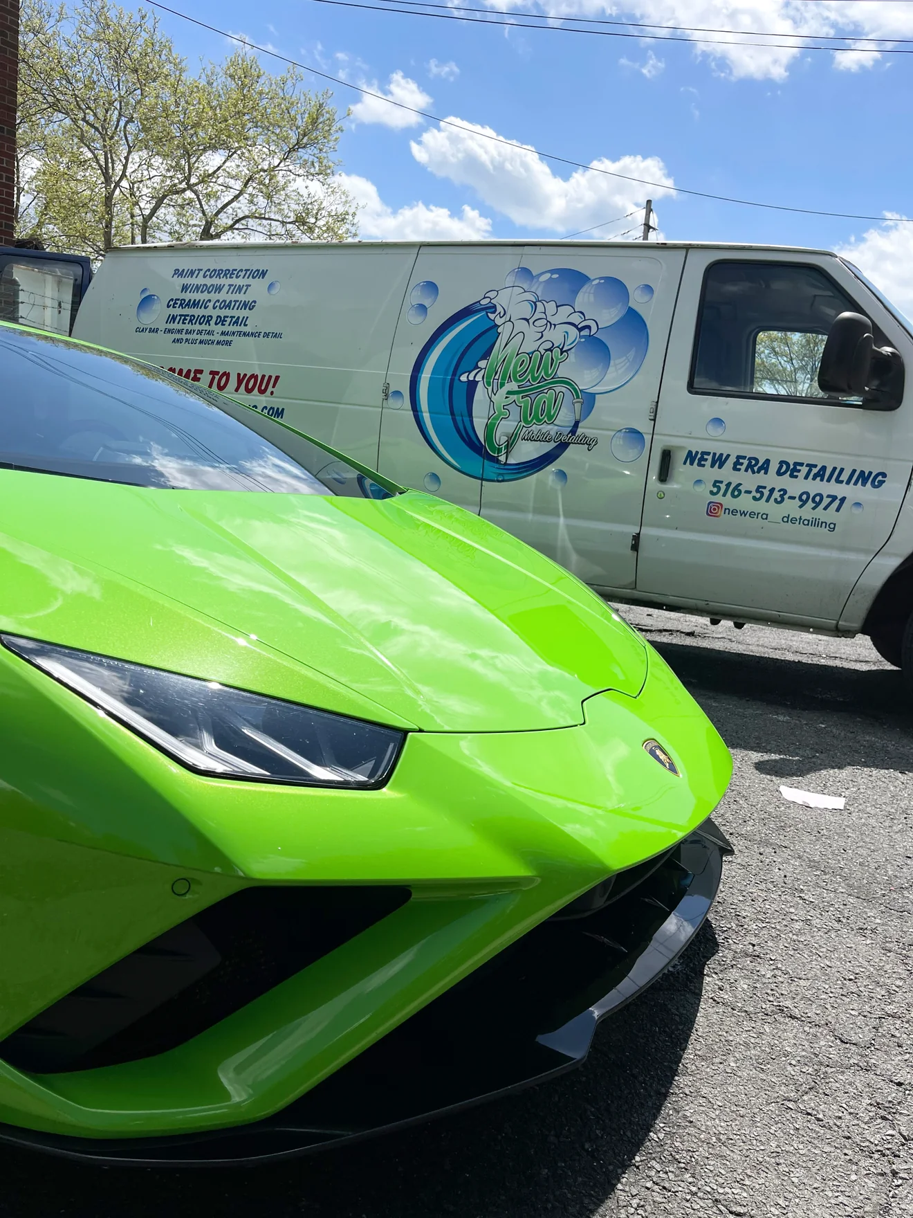 A bright green Lamborghini with the branded New Era service van behind it